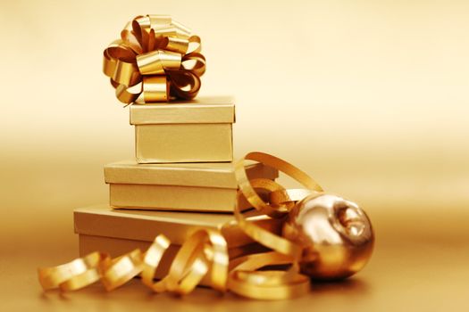golden christmas gifts on gold background 