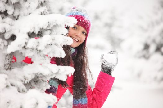 winter woman play snowballs on snow background