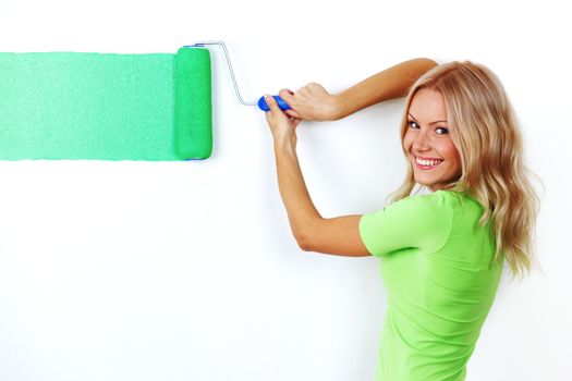 woman paints the wall brush