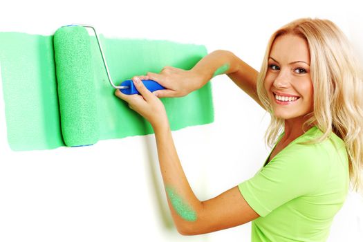 woman paints the wall brush