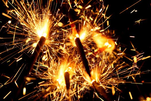 yellow sparkler holiday background on black