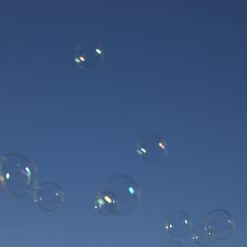 Soap bubbles in the blue sky