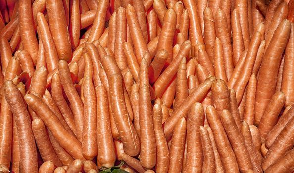 Heap of carrots for sale in a market place.