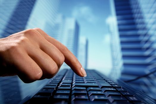 reseller work on keyboard skyscrapers on background