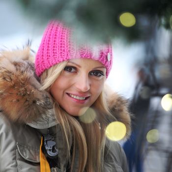 woman in winter hat and holyday bokeh