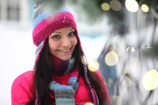 woman in winter hat and holyday bokeh