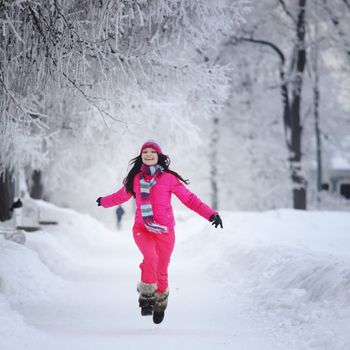 woman run in winter park very happy