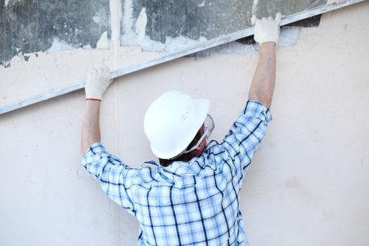 worker aligns wall for directing