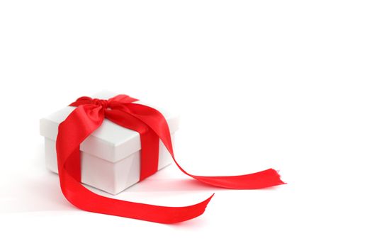 white christmas gift with red ribbon