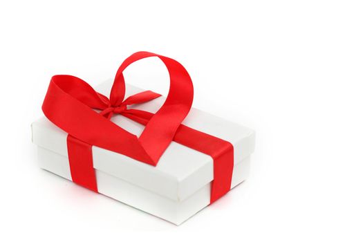  white christmas gift with red heart ribbon