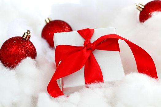  white christmas gift with red heart ribbon
