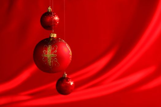  christmas balls on red satin background