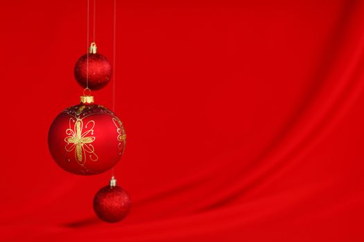  christmas balls on red satin background