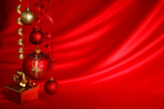 christmas balls on red satin background