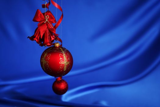 red christmas balls on blue satin background