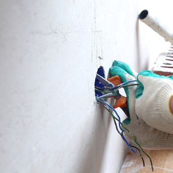 worker puts the wires in the wall