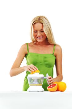 woman squeezes juice by juicer