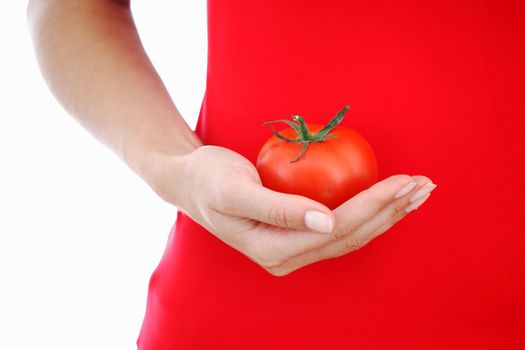 tomato in woman hands close up