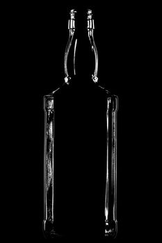 contour of an alcohol bottle shot with back lignt technique, against black