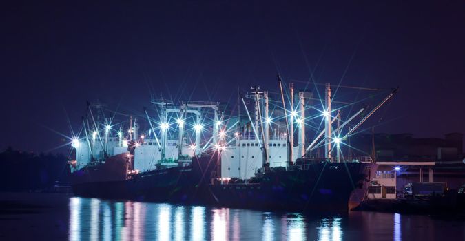 Industrial shipping port at night in Bangkok, Thailand