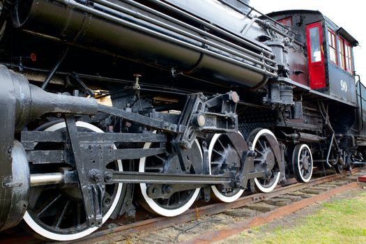 Old Black Steam Locomotive Train with closeup of wheels and boiler