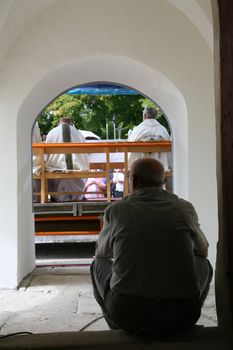 Man sitting at the door of the church
