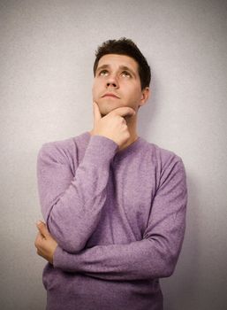 Young man lost in thought and looking up