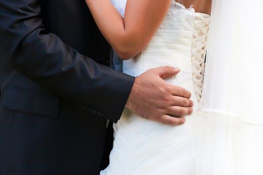Bride and groom embrace each other on their wedding day