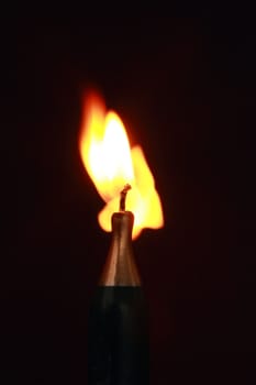a lit bottle shaped candle