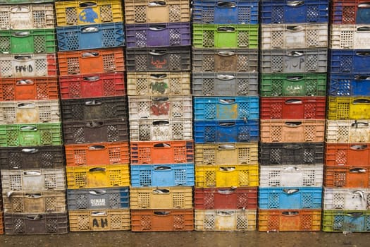 Stack of colorful packing cases containing recently landed fish in the fishing village of Essaouira, Morocco.
