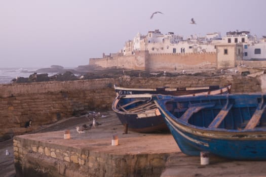 Small fishing boats on the dockside in the historic seaside village of Essaouira in Morocco.