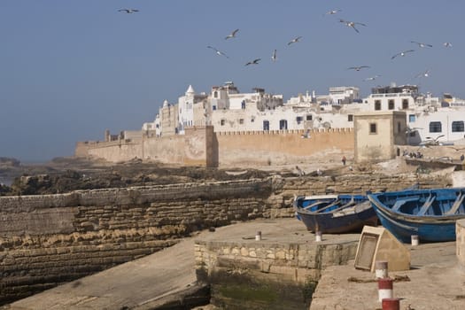 Small fishing boats on the dockside in the historic seaside village of Essaouira in Morocco.