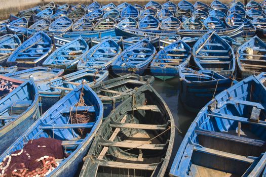 Fleet of small wooden fishing boats in the fishing village of Essaouira, Morocco.