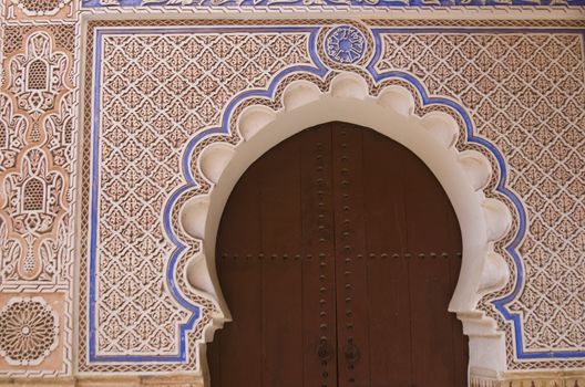 Entrance to a traditional riad in the shape of a key hole in Marrakesh, Morocco