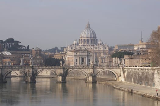 Dome of St Peters rising over the River Tiber in Rome, Italy