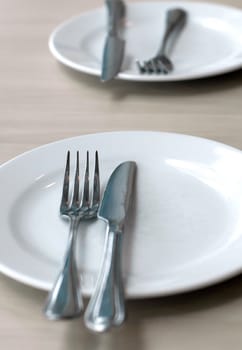 Empty kitchen plate, spoon and table-knife