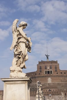 Statue of an Angel on the bridge (Pont Sant' Angelo) over the River Tiber leading to the ancient Castel Sant' Angelo in Rome, Italy.