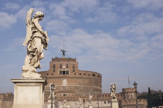 Statue of an Angel on the bridge (Pont Sant' Angelo) over the River Tiber leading to the ancient Castel Sant' Angelo in Rome, Italy.