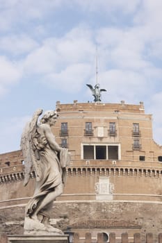 Statue of an Angel on the bridge (Pont Sant' Angelo) over the River Tiber leading to the ancient Castel Sant' Angelo in Rome, Italy.