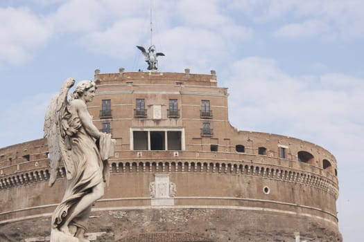 Statue of an Angel on the bridge (Pont Sant' Angelo) over the River Tiber leading to the ancient Castel Sant' Angelo in Rome, Italy.