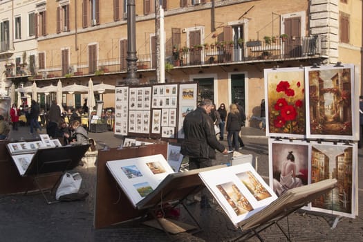 Local artists selling paintings at the open air market in Piazza Navona in Rome, Italy