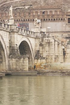 Statues line the bridge (Pont Sant' Angelo) over the River Tiber leading to the ancient Castel Sant' Angelo in Rome, Italy.