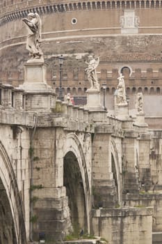 Statues line the bridge (Pont Sant' Angelo) over the River Tiber leading to the ancient Castel Sant' Angelo in Rome, Italy.
