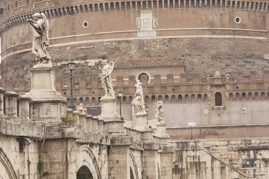 Statues line the bridge (Pont Sant' Angelo) over the River Tiber leading to the ancient Castel Sant' Angelo in Rome, Italy.