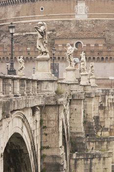 Statues line the bridge (Pont Sant' Angelo) over the River Tiber leading to the ancient Castel Sant' Angelo in Rome, Italy.