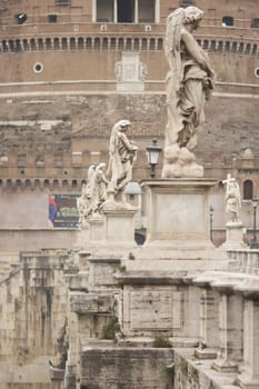Statues line the bridge (Pont Sant' Angelo) over the River Tiber leading to the ancient Castel Sant' Angelo in Rome, Italy.