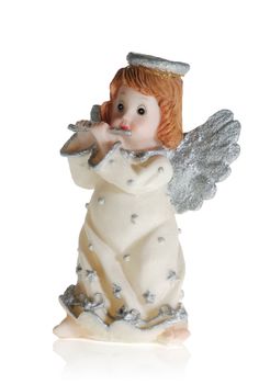 Toy - an angel playing on a flute. It is isolated on a white background