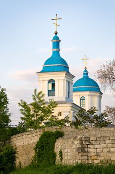 Orthodox christian church behind the wall, in Chisinau, Moldova, at sunset.