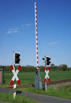 Level crossing with open barrier.