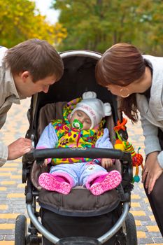 Young family in autumn walk in the park